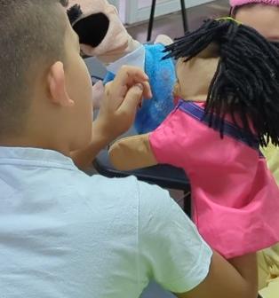 Children playing with puppets